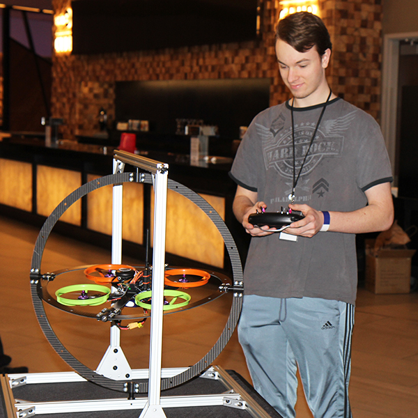 Students flying a drone in a test harness